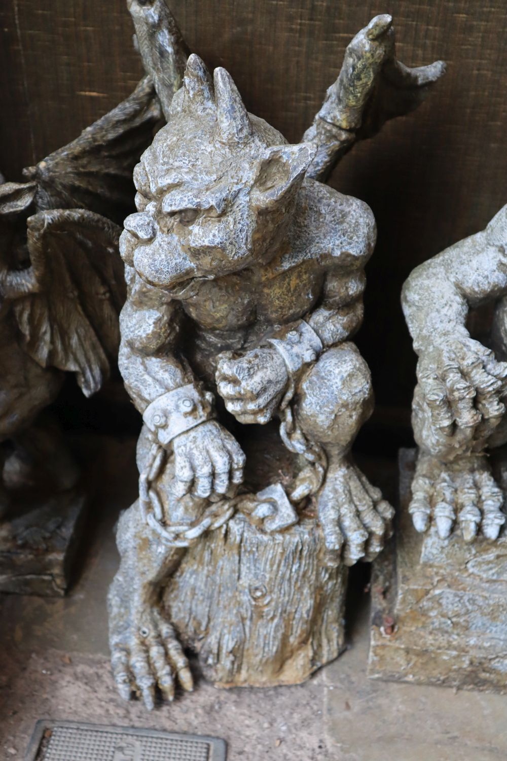 Three composition gargoyle garden ornaments and a reconstituted stone garden ornament, tallest 60cm